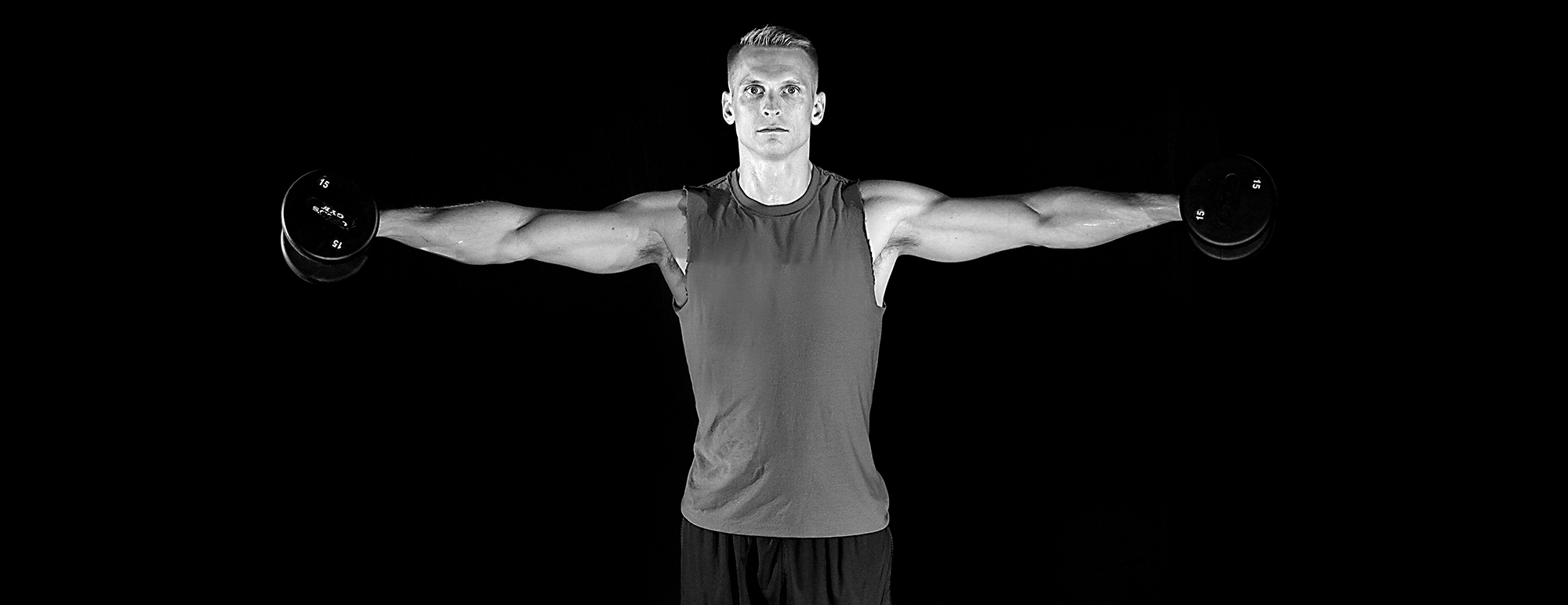 Smart Fitness member performing a dumbbell lateral raise