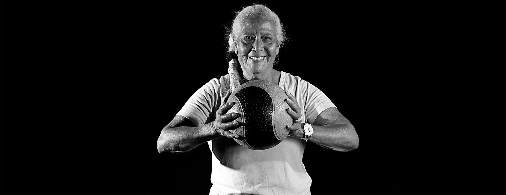 Smiling Smart Fitness member training with a medicine ball
